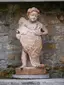 Statue of putto with a shield in the Artist garden in Nusle